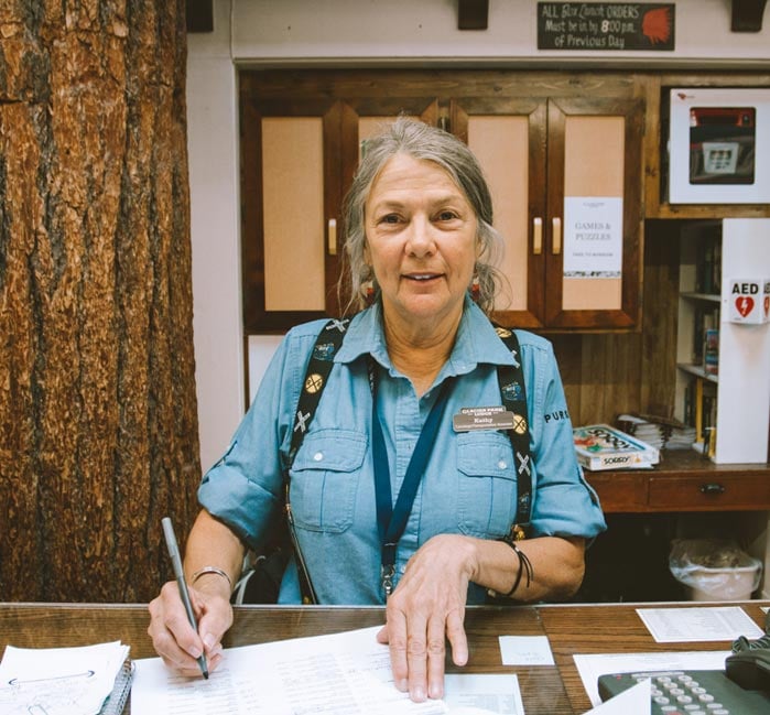 A woman works at the Glacier Park Lodge front desk.