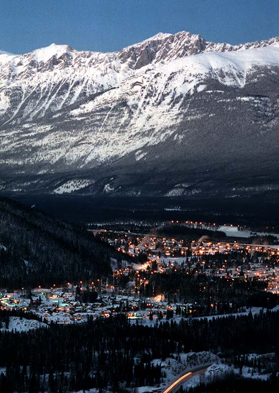 The town of Jasper lit up with lights in the winter time.