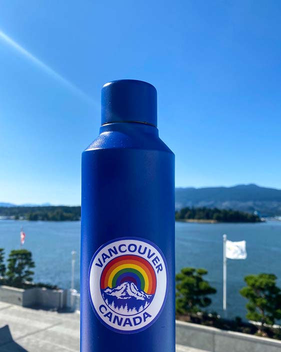 A waterbottle with a Vancouver Canada rainbow sticker on it.